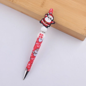 Detail of Santa Claus silicone bead and Ho! Ho! text print on the red Christmas ballpoint pen