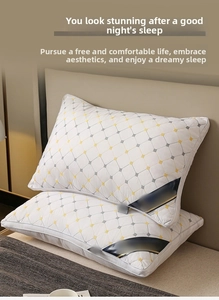 Close-up of luxury white hotel pillows with gold and grey diamond quilted patterns