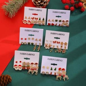 Detail of Christmas stud earrings set featuring Santa, reindeer, and snowflakes on a card