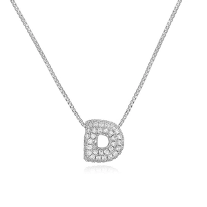 Macro shot of silver letter D pendant with cubic zirconia on a sleek box chain
