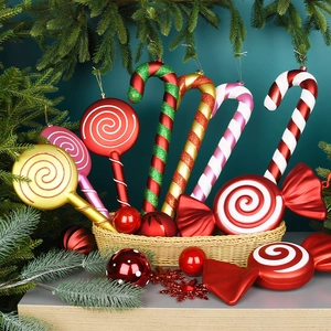 Red and white Christmas candy cane and lollipop ornaments in a festive gift basket