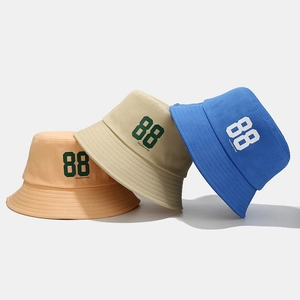 Three cotton bucket hats in pink, beige and blue with number 88 print in street style