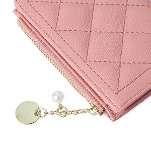 Detail of pink quilted leather wallet featuring pearl pendant and gold zipper accents