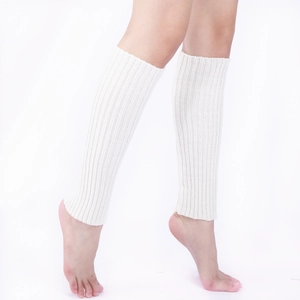 Detail of cream white ribbed knit leg warmers showing elastic texture on model calf