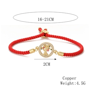 Macro detail of red woven Tree of Life bracelet with 2cm gold copper pendant dimensions