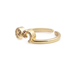 Adjustable gold butterfly ring with red and white zircon stones on a white background