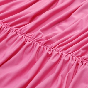 Detail of pink ruched fabric showing the elegant pleated design and soft texture