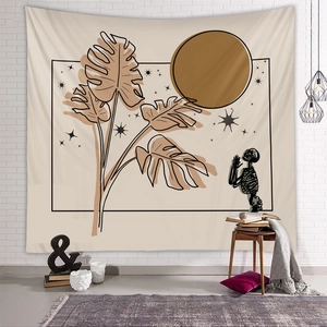 Close-up of skeleton tapestry with monstera leaves and moon on white brick wall background