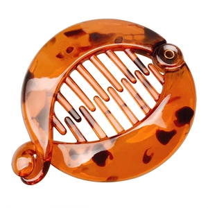 Macro shot of tortoise shell pattern banana hair clip with internal teeth and glossy finish