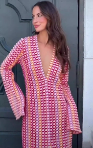Detail of V-neck crochet maxi dress with colorful geometric knit pattern and bell sleeves