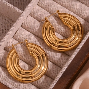 Macro shot of 18K gold plated hollow hoop earrings with textured ridge detailing