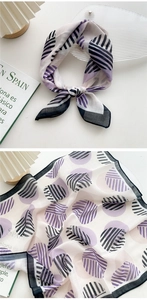 Detailed close-up of cotton linen scarf with purple geometric prints and stitching detail