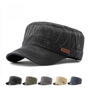 Detail view of cotton flat top cadet caps in black, grey, green, khaki, and navy blue