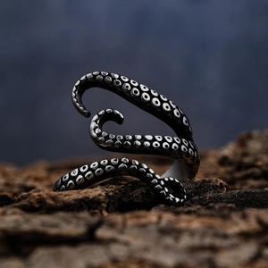 Gothic octopus tentacle ring in vintage silver finish on natural tree bark background