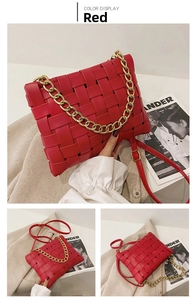 Macro detail of red woven faux leather handbag with chunky gold chain and slim strap