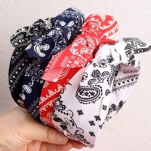 Three paisley print headbands with rabbit ear bows in navy blue, red, and white cotton fabric