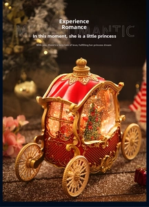 Close-up of a red pumpkin carriage music box with gold details and a festive interior