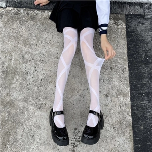 Macro detail of white geometric pattern pantyhose with cross lines on a model