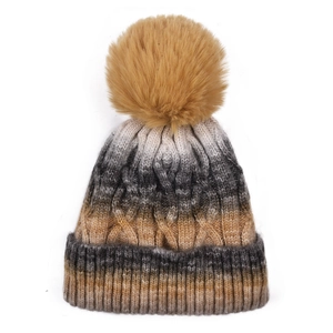 Detailed knit texture and gradient color flow on a winter beanie with pompom