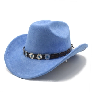 Detail of blue faux suede fedora hat with ethnic style buckle on black decorative band