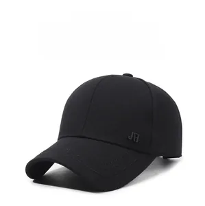 Detail of classic black baseball cap featuring a small metal logo and reinforced brim