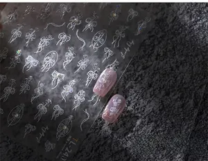 Macro detail of TL-240 5D embossed nail stickers with bows and floral motifs