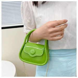 Close-up of vibrant green mini jelly bag with glossy finish and elegant gold chain strap