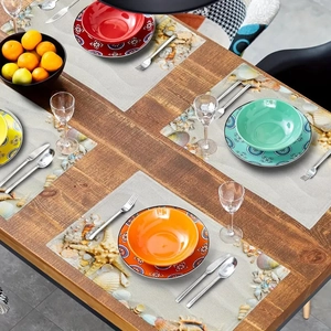 Overhead view of rectangular beach shell placemats with colorful ceramic tableware