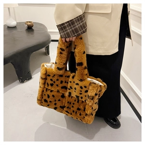Detailed close-up of fluffy cow pattern faux fur tote bag with soft plush texture