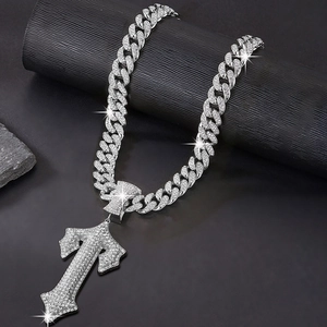 Macro detail of high-quality silver hip hop necklace with icy paved sword cross pendant