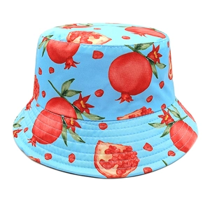 Close-up of sky blue sun hat featuring vibrant red pomegranate patterns and premium stitching