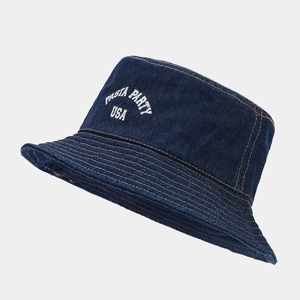 Detailed view of the navy denim bucket hat with USA embroidery and yellow stitching