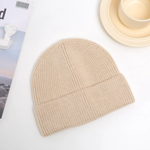 Detail of beige ribbed knit beanie texture with elegant minimalist lifestyle decor