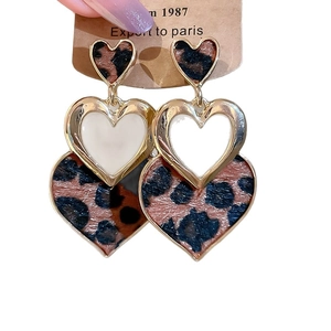 Retro triple heart leopard print earrings in gold and white on display card