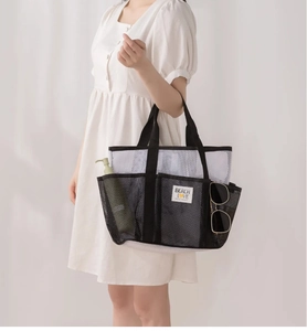 Mesh beach bag detail showing multiple pockets with Beach Love label on mesh fabric
