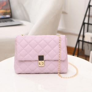 Chic lavender quilted crossbody bag with gold chain strap on marble surface