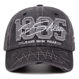 Vintage dark gray washed cotton baseball cap with 1985 embroidery and distressed edges