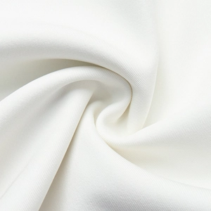Macro shot of high-quality white twill fabric showing detailed texture and soft draping