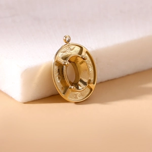 Detailed view of a gold oval four-prong pendant base for DIY jewelry making