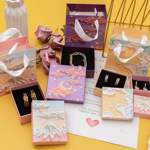Detail of oil painting style jewelry boxes with starry sky designs and matching gift bags