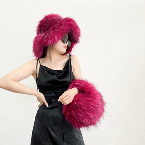 Detailed view of fluffy rose red faux fur hat and handbag set on a fashion model