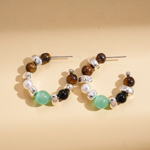 Detail of beaded hoop earrings with tiger eye, faux pearl, and green cat eye stones