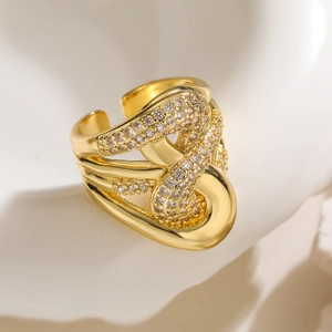 Macro shot of 18K gold plated geometric ring with intertwined layers and zircon stones
