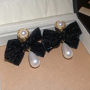 Elegant black beaded bow earrings with water drop pearls and gold-tone studs for women