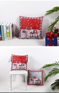 Close-up of red and grey Christmas cushion covers with Nordic gnome and snowflake patterns