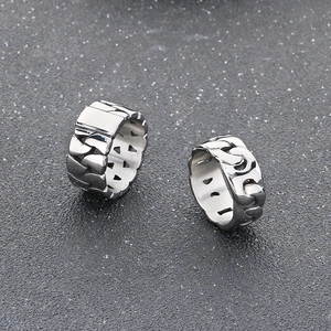 Macro view of silver Cuban link rings with polished stainless steel texture details