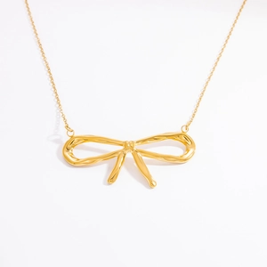 Macro detail of high-quality 18k gold-plated butterfly pendant with a polished finish