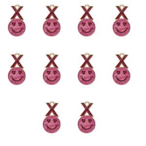 Macro view of 10 red glitter X-shape and pink glitter heart-eye smiley face pendants