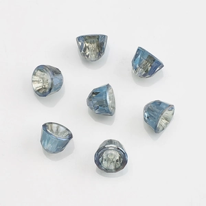 Macro shot of 8mm blue faceted cone-shaped crystal beads on white background