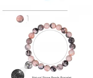 Macro detail of 8mm pink zebra stone beads and heart projection pendant with dimensions